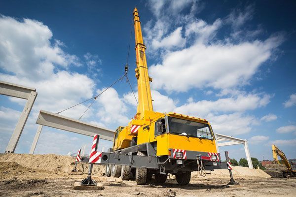 Truck-mounted crane lifting on site