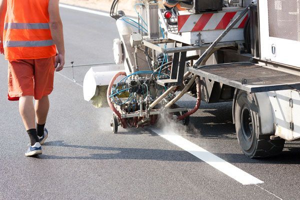 Line marking machine working on a new road surface